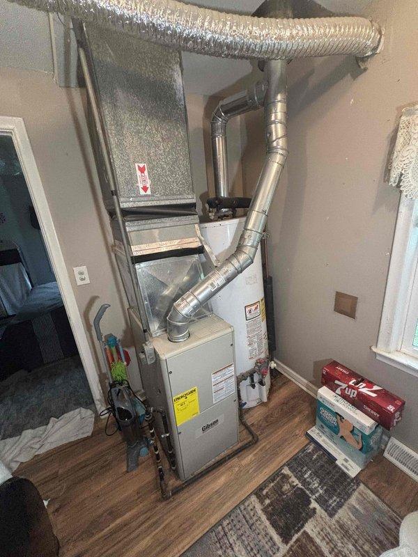 Provided estimate for replacement of existing 2004 Hotpoint water heater that has reached end of serviceable life at 21 years old. Evaluated current installation location and confirmed property is site-built construction, not mobile or manufactured home. Documented existing HVAC system configuration including Payne furnace installation and ductwork routing for reference during future water heater replacement to ensure proper clearances and access are maintained.