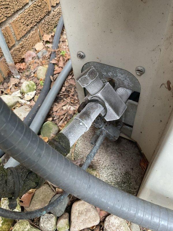 Completed annual cooling maintenance on 26-year-old ICP air conditioning system. Performed comprehensive tune-up including inspection of outdoor unit components, refrigerant line connections, and service valves. System evaluated and documented with photos showing exterior linesets, connection points, and equipment condition with visible weathering consistent with age of unit.