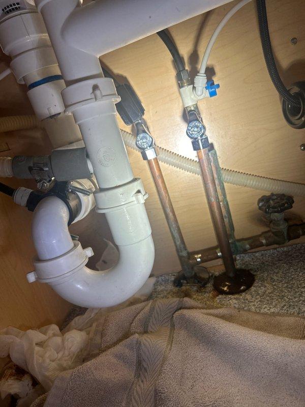 Responded to emergency plumbing leak at kitchen sink. Upon arrival, identified active leak at shut-off valve union connection under sink. Shut off water supply, removed faulty union fitting, cleaned threads, and installed new compression union with proper sealing. Tested system under full pressure to confirm leak was eliminated. Inspected surrounding plumbing connections and water heater installation for additional issues. No further leaks detected upon completion.