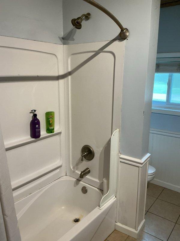 Responded to bathtub and shower fixture replacement request due to severely diminished water pressure. Accessed plumbing from attic space above bathroom to diagnose supply line restrictions. Replaced bathtub faucet assembly, shower valve cartridge, and showerhead with new fixtures in bronze finish to match existing décor. Restored full water pressure and verified proper operation of all controls and drainage system.