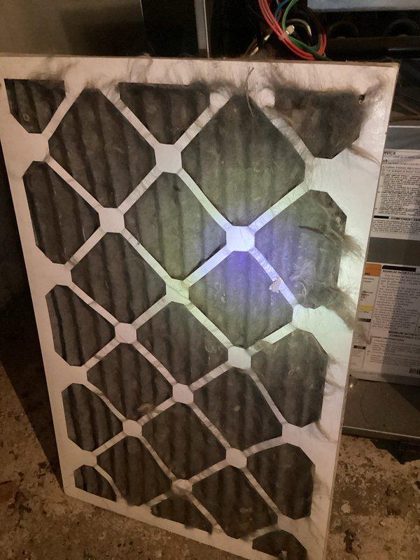 Responded to no heat call where customer reported burning rubber smell after hearing click from furnace following thermostat adjustment. Upon arrival, found furnace shut off as safety precaution. Inspection revealed severely clogged air filter with heavy dust and debris accumulation restricting airflow. Dirty filter caused system to overheat, triggering safety limits and producing burning odor. Replaced contaminated filter with new unit, verified proper airflow restoration, and tested system operation. Furnace restarted successfully with no abnormal odors or sounds. All electrical connections and components inspected and found secure. System cycling normally, delivering heat as designed.