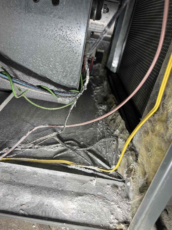 Completed annual cooling maintenance on 6-year-old EnergiAir system with warranty through March 2029. Performed comprehensive inspection of air handler unit, noting significant dust and debris accumulation on evaporator coil and interior surfaces. Documented extensive corrosion and deterioration on galvanized metal ductwork and plenum in attic space, indicating prolonged moisture exposure. Inspected control board and low-voltage wiring connections, verifying all electrical terminations secure. Captured photographic documentation of equipment condition including interior coil assembly and corroded ductwork for maintenance records.