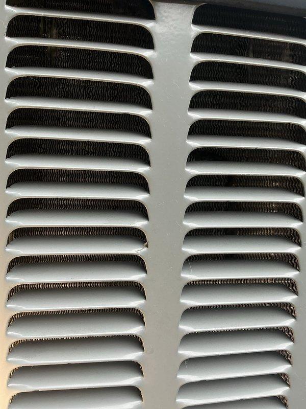 # AC Annual Cooling Visit - EnergiAir System

Completed annual cooling maintenance on 4-year-old EnergiAir system under warranty through June 2031. Upon inspection, discovered significant ice and frost accumulation on evaporator coil and internal metal panels, indicating restricted airflow or potential refrigerant charge issues. 

Performed comprehensive diagnostic evaluation to identify root cause of icing condition. Checked airflow through supply and return vents, which appeared clean and unobstructed with properly functioning louvers. Examined evaporator coil access panel revealing extensive crystalline frost buildup across central and right portions of coil surface with visible condensation and moisture droplets.

Assessed multiple potential causes including: restricted airflow from dirty filter or blocked return air path, low refrigerant charge, malfunctioning metering device, or blower motor operating below specification. Inspected refrigerant lines and connections for signs of l