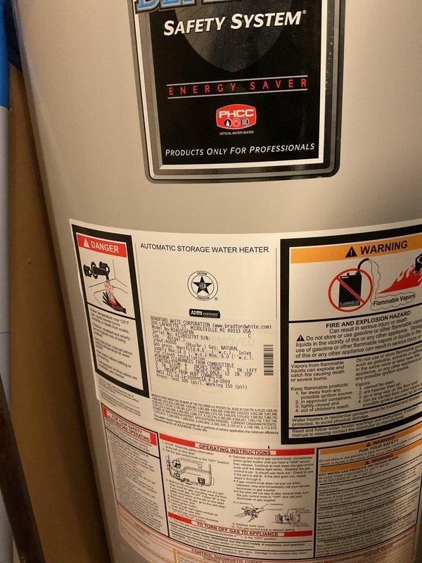 Responded to no hot water complaint on 13-year-old Bradford White water heater that was repeatedly tripping the electrical breaker. Upon inspection, documented the unit's condition and verified the safety system labeling and energy saver features were intact. Evaluated the electrical components and heating elements for potential short circuits or ground faults that would cause breaker trips. Completed diagnostic assessment and photographic documentation of the water heater installation and surrounding utility area for service records.