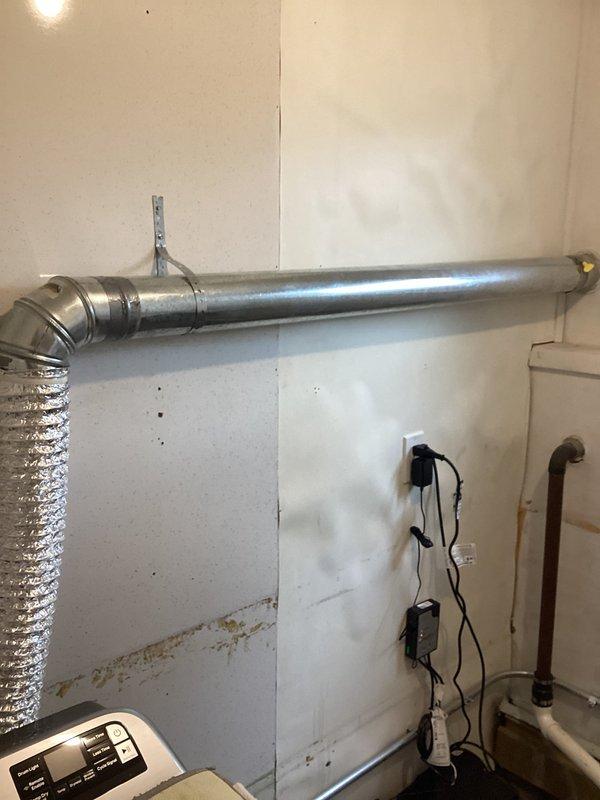 Completed installation of battery backup sump pump system in basement location. Installed primary sump pump in concrete pit with PVC discharge piping running vertically to overhead connection point. Mounted wall-mounted control panel with indicator lights and installed floor-level battery backup unit with all necessary electrical connections and cabling between components. System tested and operational, providing automatic backup protection during power outages.