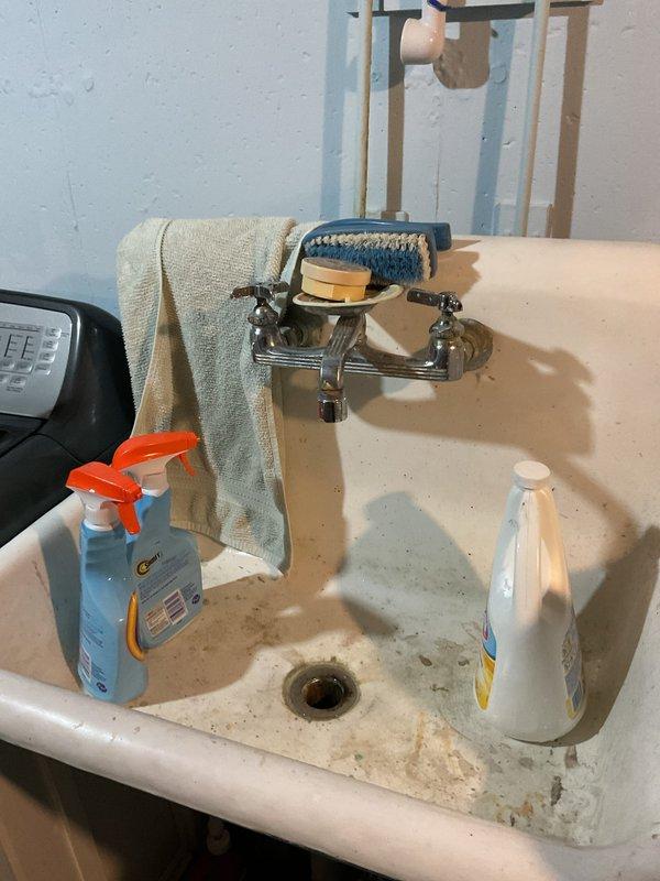 Responded to basement odor complaint originating from sink and floor drain area. Upon inspection, identified deteriorated ceiling materials with visible water damage and staining near plumbing infrastructure. Examined bathroom sink showing signs of wear and assessed utility area containing water heater with connected supply lines and vertical PVC drain pipe. Documented conditions of plumbing fixtures, drainage system components, and surrounding areas affected by moisture intrusion. Recommended addressing water damage to ceiling materials and ensuring proper trap seals in both sink and floor drain to eliminate sewer gas odors entering the living space.
