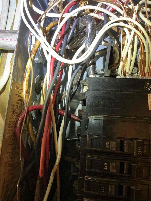 Responded to service call for ceiling fixture inspection due to water damage. Upon arrival, documented existing electrical panel conditions showing outdated wiring installation with disorganized cable management, accumulated dust and debris, and signs of aging throughout the system. Photographed circuit breaker box assembly revealing multiple circuits with various colored conductors in need of proper organization and potential code compliance review. Recommended follow-up electrical safety evaluation to address wire bundling concerns and overall panel condition.