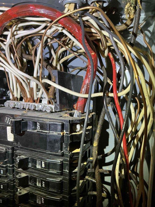 Responded to service call for ceiling fixture inspection due to water damage. Upon arrival, documented existing electrical panel conditions showing outdated wiring installation with disorganized cable management, accumulated dust and debris, and signs of aging throughout the system. Photographed circuit breaker box assembly revealing multiple circuits with various colored conductors in need of proper organization and potential code compliance review. Recommended follow-up electrical safety evaluation to address wire bundling concerns and overall panel condition.