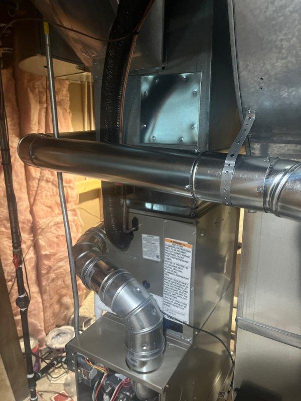 Completed full HVAC system replacement including installation of new Carrier air conditioning unit on exterior concrete pad with proper refrigerant line routing and securing to building exterior, and new furnace/air handler installation in attic space with metallic ductwork connections and proper insulation clearances. All equipment positioned per manufacturer specifications with secure mounting, appropriate electrical connections, and condensate drainage provisions. System tested and operational upon completion.