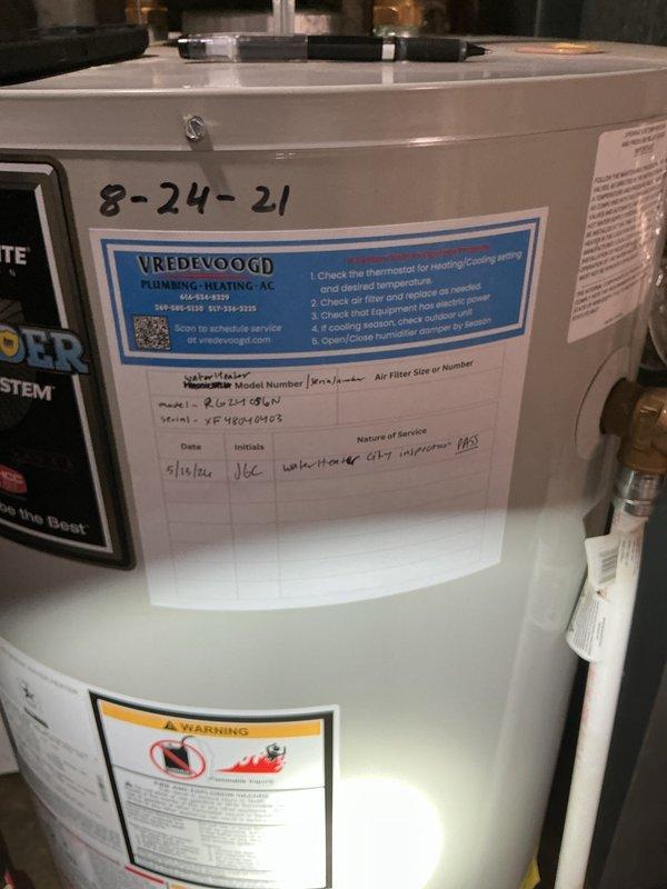 Completed rental inspection of water heater and furnace at residential property. Water heater identified as Defender Safety System model with installation date of 8-24-21 and recent service performed on 5/18/24. Documented 7-year-old Amana furnace and photographed all equipment conditions for rental property records.