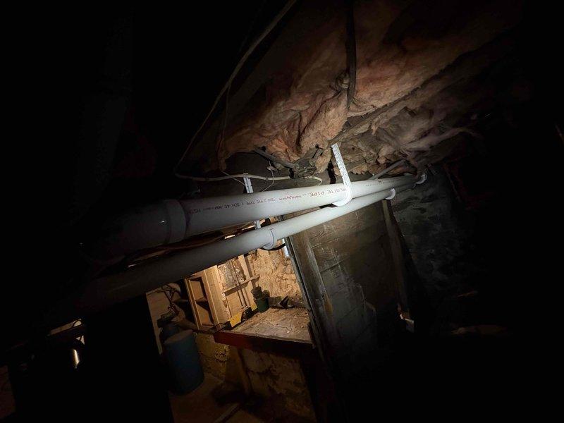 Completed estimate for 10-year-old water heater replacement. Inspected existing installation in crawlspace area, documented current plumbing configuration including 2-inch PVC drainage lines and access conditions. Photographed existing infrastructure and provided customer with replacement options and recommendations.