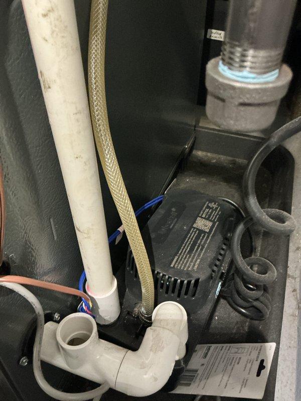 Completed annual cooling maintenance on EnergiAir system including full inspection of condenser unit and indoor components. Observed normal weathering on exterior louvers with minor dust accumulation on coil fins; condensate drain system and associated plumbing connections inspected and found operational. Unit photographed for service records and system confirmed operating within manufacturer specifications.