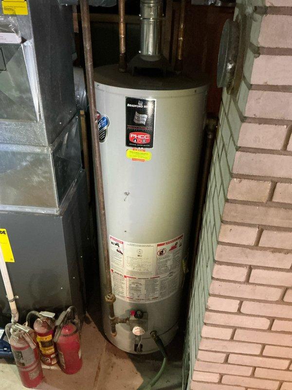 Conducted on-site evaluation for whole home air conditioning system replacement. Existing equipment is 20-25 years old and has reached end of serviceable life. Assessed current HVAC infrastructure in basement utility area, including furnace configuration, ductwork layout, and available installation space. Documented existing system setup with photos showing gray metal furnace unit with connected ductwork, PVC condensate drain line, and electrical connections. Evaluated structural considerations for new equipment placement alongside water heater and existing heating system. Provided comprehensive estimate for complete air conditioning system replacement including outdoor condensing unit, indoor evaporator coil, refrigerant lines, electrical upgrades, and integration with current forced air distribution system.