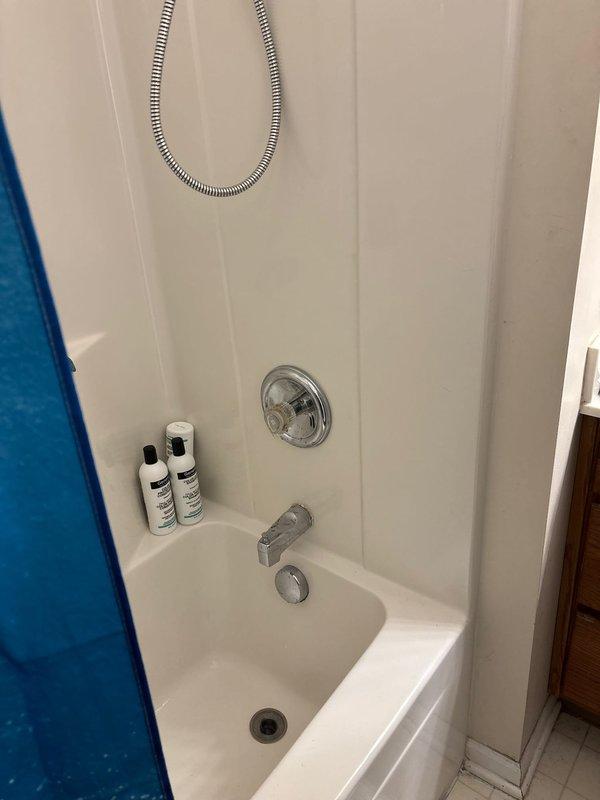 Completed Moen cartridge replacement on tub/shower valve assembly. Removed existing single-handle control valve trim, extracted worn cartridge, and installed new Moen replacement cartridge. Tested operation of diverter and temperature control to ensure proper hot/cold water mixing and smooth handle operation. Reassembled trim components and verified no leaks at connections. System restored to full functionality with improved handle operation and temperature control.