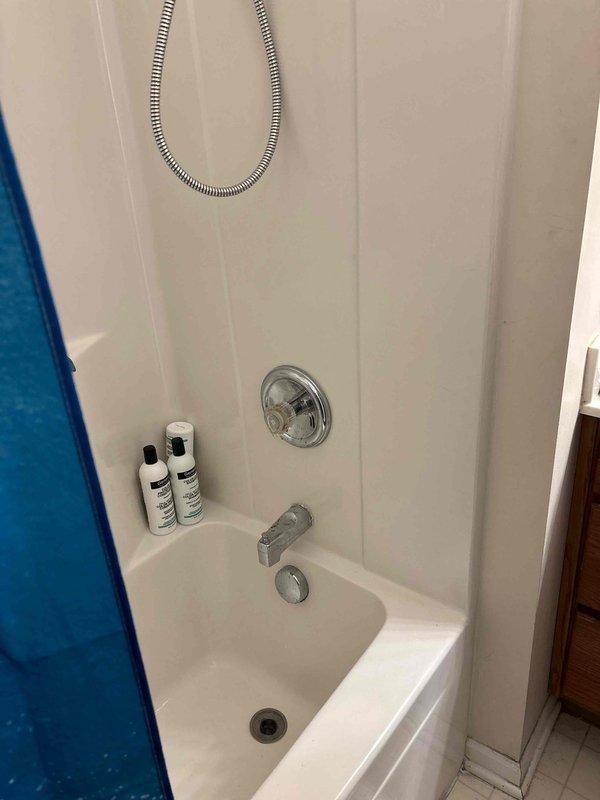 Completed Moen cartridge replacement on tub/shower valve assembly. Removed existing single-handle control valve trim, extracted worn cartridge, and installed new Moen replacement cartridge. Tested operation of diverter and temperature control to ensure proper hot/cold water mixing and smooth handle operation. Reassembled trim components and verified no leaks at connections. System restored to full functionality with improved handle operation and temperature control.