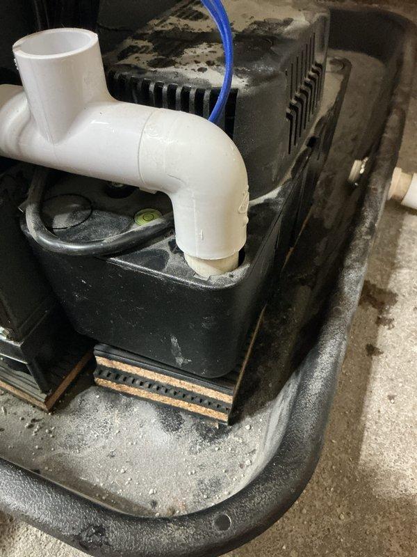 Completed annual cooling maintenance on AC system. Performed comprehensive tune-up inspection including checking refrigerant levels, electrical connections, and condensate drainage system. Inspected outdoor unit and confirmed no manufacturer's label cover exists for this model as these components are not standard equipment for this unit type. Photographed condensate pump assembly and drainage pan showing normal operational condition with minor debris accumulation around base. All systems tested and operating within manufacturer specifications.