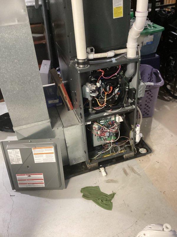 Responded to heating system concern following basement sewer water backup of 12-18 inches. Performed thorough inspection of furnace and internal components to assess potential water damage. Opened unit panels to examine electrical connections, circuit boards, blower assembly, and control systems for moisture intrusion or contamination. Verified all wiring, safety controls, and mechanical components were dry and unaffected by the flooding event. Documented equipment condition with photographs showing no visible water damage to furnace cabinet, internal electronics, or surrounding mechanical systems. Confirmed unit operational integrity and advised system remains safe for continued use.