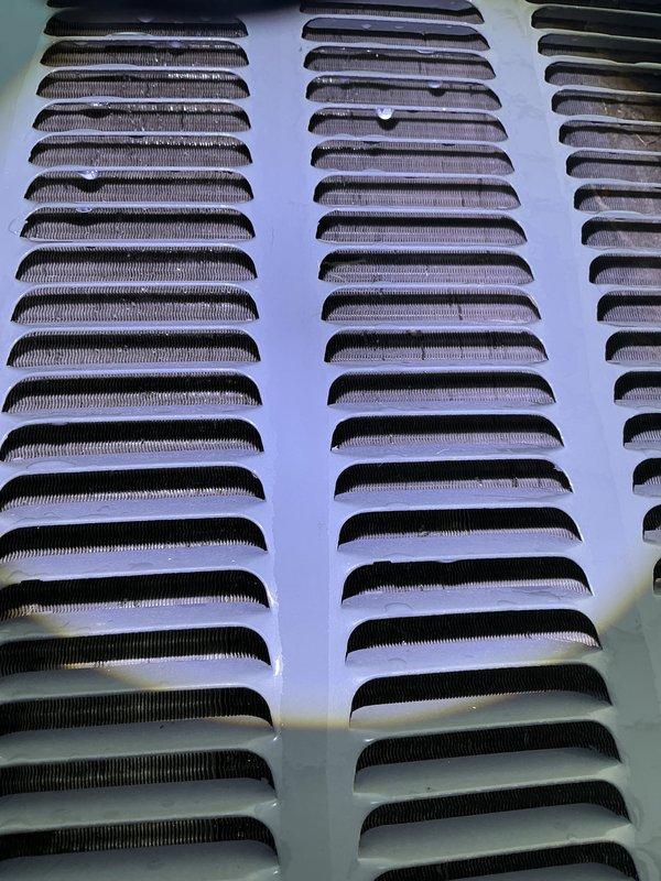 Completed annual AC tune-up and cooling system inspection under EnergiAir maintenance agreement. Documented condition of exterior ventilation louvers, noting significant dust and debris accumulation within grille slats requiring future cleaning attention to maintain optimal airflow. All routine maintenance tasks performed per manufacturer specifications.
