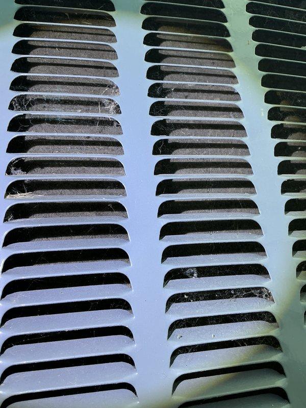 Completed annual AC tune-up and cooling system inspection under EnergiAir maintenance agreement. Documented condition of exterior ventilation louvers, noting significant dust and debris accumulation within grille slats requiring future cleaning attention to maintain optimal airflow. All routine maintenance tasks performed per manufacturer specifications.