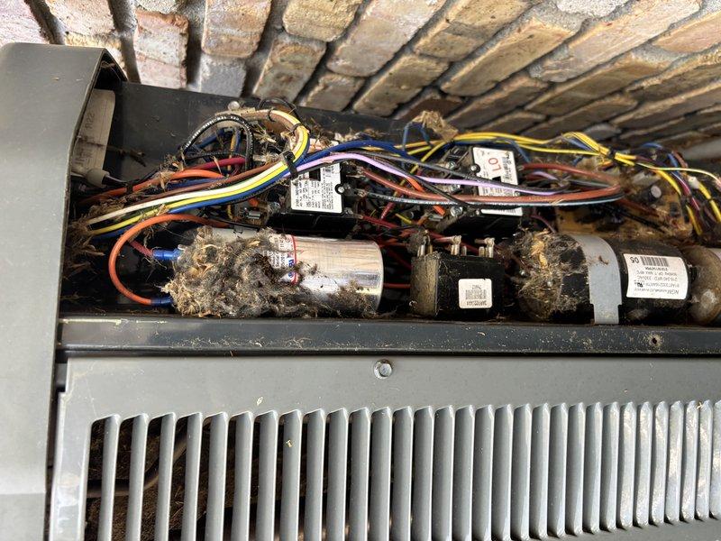 Completed comprehensive AC Super Tune-up on 18-year-old Trane heat pump system. Performed thorough inspection of indoor air handler compartment, including electrical components, capacitors, blower motor assembly, and evaporator coil. Cleaned accumulated dust and debris from capacitors, wiring connections, and surrounding mechanical components. Verified all electrical connections were secure and properly terminated. Inspected heat exchanger fins and confirmed proper airflow pathway through evaporator coil. Documented pre-existing conditions showing significant dust accumulation on capacitors and electrical components, which were addressed during service. All components tested and operating within manufacturer specifications upon completion.
