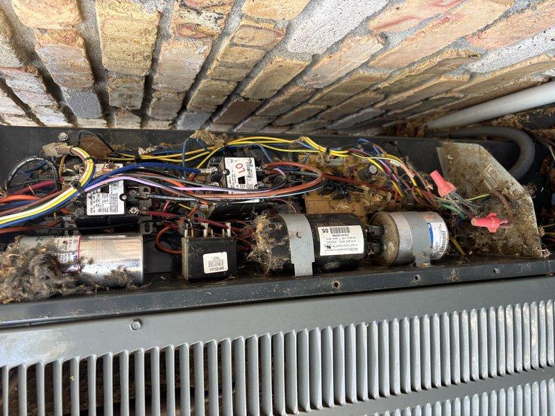Completed comprehensive AC Super Tune-up on 18-year-old Trane heat pump system. Performed thorough inspection of indoor air handler compartment, including electrical components, capacitors, blower motor assembly, and evaporator coil. Cleaned accumulated dust and debris from capacitors, wiring connections, and surrounding mechanical components. Verified all electrical connections were secure and properly terminated. Inspected heat exchanger fins and confirmed proper airflow pathway through evaporator coil. Documented pre-existing conditions showing significant dust accumulation on capacitors and electrical components, which were addressed during service. All components tested and operating within manufacturer specifications upon completion.