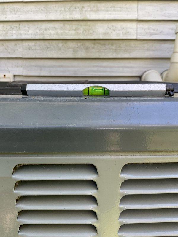 Completed annual cooling maintenance on 7-year-old EnergiAir system with warranty coverage through February 2028. Verified outdoor condensing unit was properly leveled using precision level tool to ensure optimal operation and proper refrigerant flow. Inspected exterior cabinet condition, ventilation louvers, and mounting stability. Unit found to be within acceptable level tolerance for continued efficient operation. All components accessible and functioning as designed.