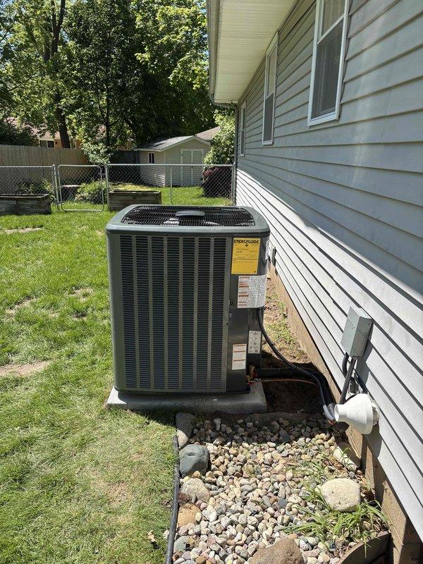 Completed full air conditioning system replacement at residential property. Installed new condensing unit on existing concrete pad with decorative rock bed surround, positioned adjacent to exterior wall with proper clearances. Unit charged with 88 oz refrigerant per factory specifications with no additional field charge required. Connected refrigerant lines with brass service valves and insulated suction line, verified all connections secure and leak-free. System tested and operational, ready for service.