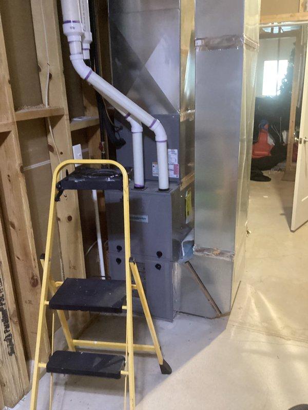 Responded to carbon monoxide alarm activation in mechanical room and upper level of residence. Upon arrival, inspected 11-year-old HVAC system and conducted safety assessment of equipment and venting components. Verified proper operation of furnace combustion and examined PVC venting system for blockages or improper installation. Tested CO levels throughout affected areas and confirmed safe readings. Documented existing thermostats and HVAC equipment configuration with photos for service records.
