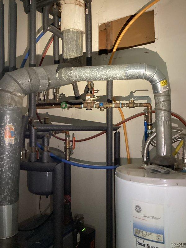 Conducted on-site assessment for garbage disposal installation project. Evaluated existing under-sink plumbing configuration and electrical requirements for disposal unit with dedicated wall switch connection. Documented mechanical room utilities and water heater setup to determine optimal routing for disposal drain line and electrical circuit installation.
