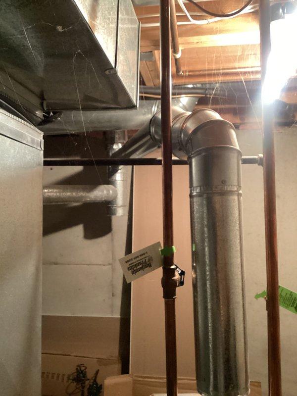 Responded to service call for water leaking from bottom of 20-year-old A.O. Smith ProMax water heater. Upon inspection, determined that the unit had reached end of serviceable life with tank leakage occurring at base, which is not repairable. Discussed repair versus replacement options with client, explaining that bottom tank leaks indicate internal corrosion and structural failure requiring full unit replacement rather than component repair. Documented existing installation with copper supply lines and proper venting configuration for replacement planning purposes.