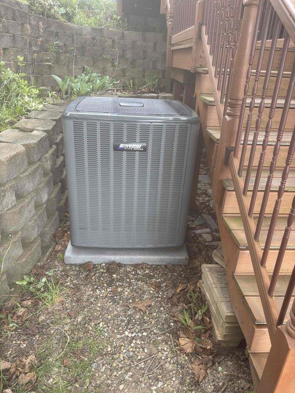 Completed add-on air conditioning system installation at residential property. Installed new outdoor condensing unit on concrete pad in side yard area between retaining wall and decorative wooden fence. Unit properly positioned with adequate clearance for airflow and service access. Routed refrigerant lines and electrical connections through covered walkway utilizing existing pergola structure. Installed flexible ductwork along exterior wall to connect new system to interior air handler. System secured, tested for proper operation, and verified all connections for leak-free performance. Installation financed through approved third-party lender and activated for immediate use.