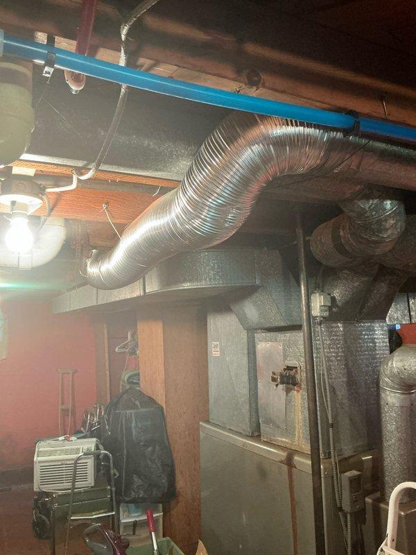 Completed furnace replacement estimate for residential property with aging HVAC system located in basement utility area. Assessed existing furnace unit showing visible wear and discoloration, documented current ductwork configuration including metallic supply ducts and flexible duct connections to air handler, and evaluated installation requirements for new equipment replacement. Customer is obtaining multiple estimates for comparison before making final decision on system upgrade.
