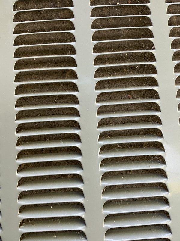 Completed annual cooling maintenance on residential AC system. Upon inspection, discovered extensive frost and ice buildup on evaporator coil and refrigerant lines, indicating restricted airflow or low refrigerant charge. Found heavily soiled return air vent grille with significant dust and debris accumulation. Addressed airflow restriction issues, cleared drain pan containing discolored condensate, and performed standard tune-up procedures including filter evaluation and system performance verification. Renewed maintenance agreement covering furnace, air conditioner, and humidifier equipment.
