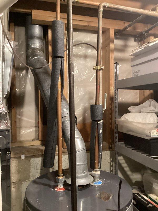 Conducted water heater replacement estimate for existing AO Smith unit located in basement utility area. Assessed current installation including copper supply lines with foam insulation sleeves, vertical venting system, and connections to existing plumbing infrastructure. Documented mechanical space configuration with exposed framing and provided recommendations for replacement equipment and installation requirements.