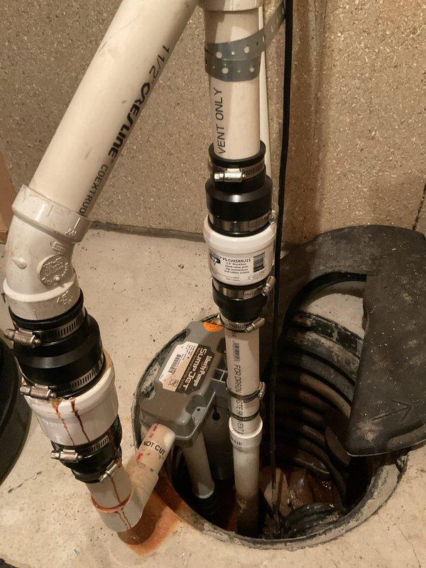Responded to customer complaint of intermittent sewer odor in basement and leaking shower head. Upon inspection, identified improper venting on sump pump system as source of sewer gas infiltration. Verified sump pump vent configuration and confirmed "VENT ONLY" labeling on vertical PVC discharge lines. Assessed all pipe connections, rubber couplings, and hose clamps for proper seal integrity. Inspected bathroom facilities including toilet and shower area to rule out additional plumbing issues contributing to odor problems. Recommended proper venting solutions to prevent negative pressure conditions that allow sewer gases to enter living space through plumbing fixtures and floor drains. Addressed shower head malfunction requiring repair or replacement to eliminate water spurting issue.
