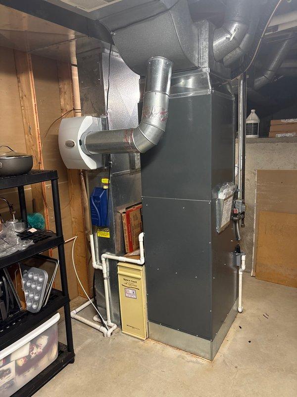 Completed full air conditioning system replacement in basement mechanical room. Removed existing AC unit and installed new condensing unit with proper refrigerant line connections. Verified furnace integration with new AC system, ensuring all ductwork connections were properly sealed and secured. Installed new PVC condensate drainage lines and tested system operation. All electrical connections completed to code, system commissioned and tested for proper cooling operation and airflow throughout the residence.