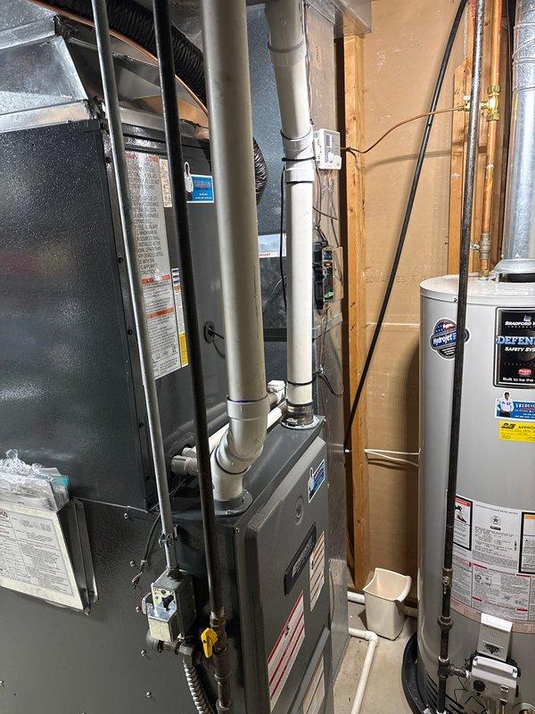 Completed full air conditioning system replacement in basement mechanical room. Removed existing AC unit and installed new condensing unit with proper refrigerant line connections. Verified furnace integration with new AC system, ensuring all ductwork connections were properly sealed and secured. Installed new PVC condensate drainage lines and tested system operation. All electrical connections completed to code, system commissioned and tested for proper cooling operation and airflow throughout the residence.