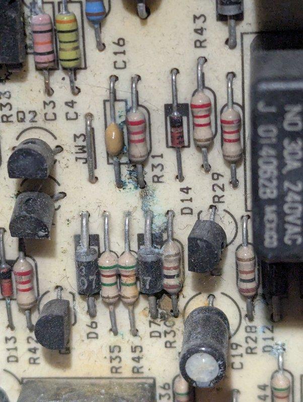 Responded to service call for 22-year-old Goodman heating system with reported thermostat issues and incomplete cycling. Customer had recently replaced thermostat batteries, but indoor fan would not activate and system failed to complete full heating cycles. Upon arrival, performed diagnostic evaluation of control board and electrical components. Inspection revealed aging furnace control board with visible signs of wear, dust accumulation, and potential corrosion near solder joints affecting circuit integrity. Documented control board condition with photos showing component degradation on PCB including resistors, capacitors, relays, and integrated circuits. Identified control board as likely source of intermittent operation and fan relay malfunction preventing proper system cycling. Provided customer with findings and repair recommendations for control board replacement to restore reliable heating system operation.