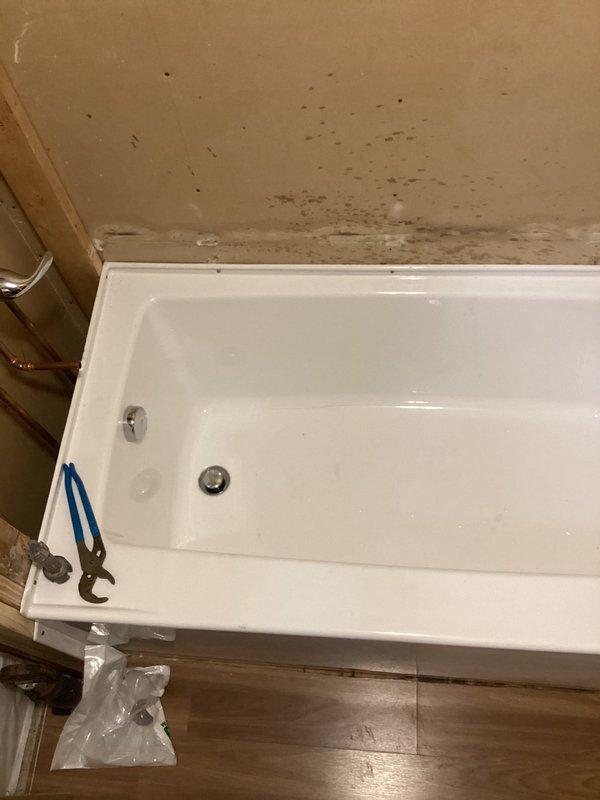 Completed installation of client-supplied bathtub and shower fixtures in active renovation space. Rough-in plumbing connections were established with galvanized supply lines, compression fittings, and PVC drain assembly through floor framing, followed by fixture mounting and trim work. All plumbing components were installed per code with proper access maintained for future service.