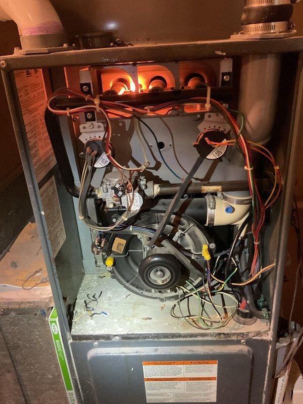 Completed comprehensive furnace super tune-up on 22-year-old Goodman gas furnace unit. Performed full system inspection, verified proper burner ignition with clean blue flame combustion across all three burner ports, tested all electrical connections and safety controls, inspected blower motor assembly and heat exchanger condition, and confirmed optimal system operation with no issues identified.