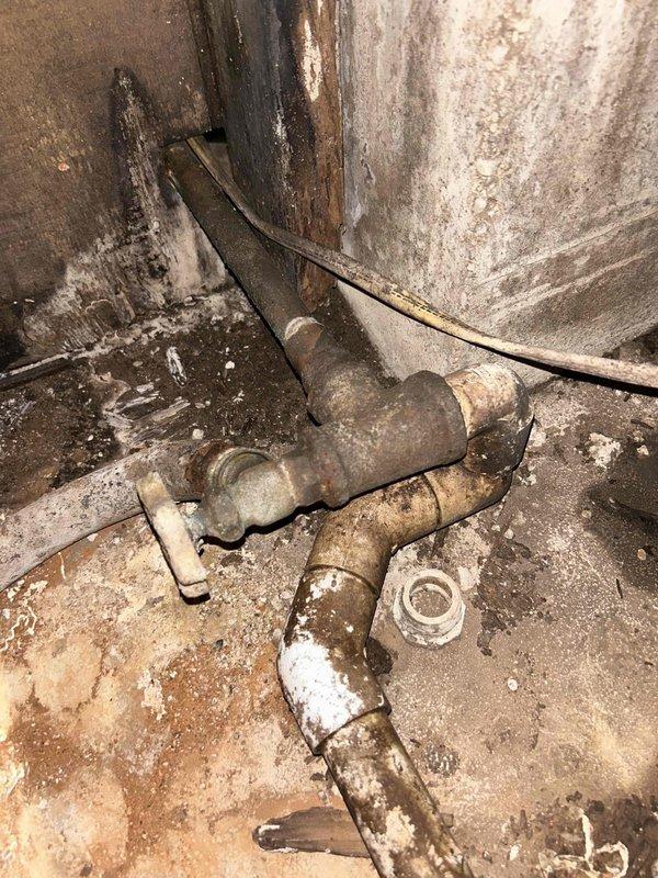 Completed comprehensive plumbing project estimate for replacement of water line from well tank throughout interior of residence. Assessment revealed severely corroded metal piping system with extensive rust penetration, deteriorated fittings and joints, and compromised structural integrity due to long-term moisture exposure and age. Documented existing conditions including corroded galvanized steel pipes, aged filter housing, and complex pipe configuration in basement crawlspace area requiring complete water line replacement to restore safe and reliable water delivery system.