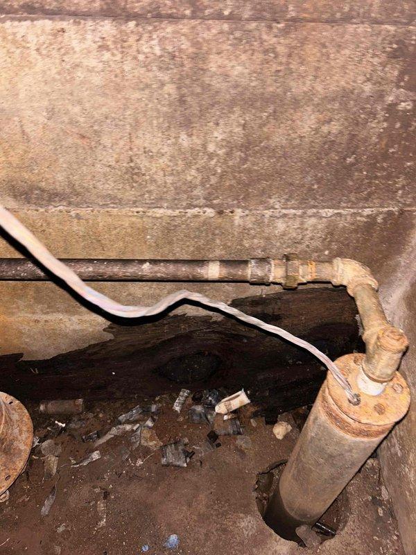 Completed comprehensive plumbing project estimate for replacement of water line from well tank throughout interior of residence. Assessment revealed severely corroded metal piping system with extensive rust penetration, deteriorated fittings and joints, and compromised structural integrity due to long-term moisture exposure and age. Documented existing conditions including corroded galvanized steel pipes, aged filter housing, and complex pipe configuration in basement crawlspace area requiring complete water line replacement to restore safe and reliable water delivery system.