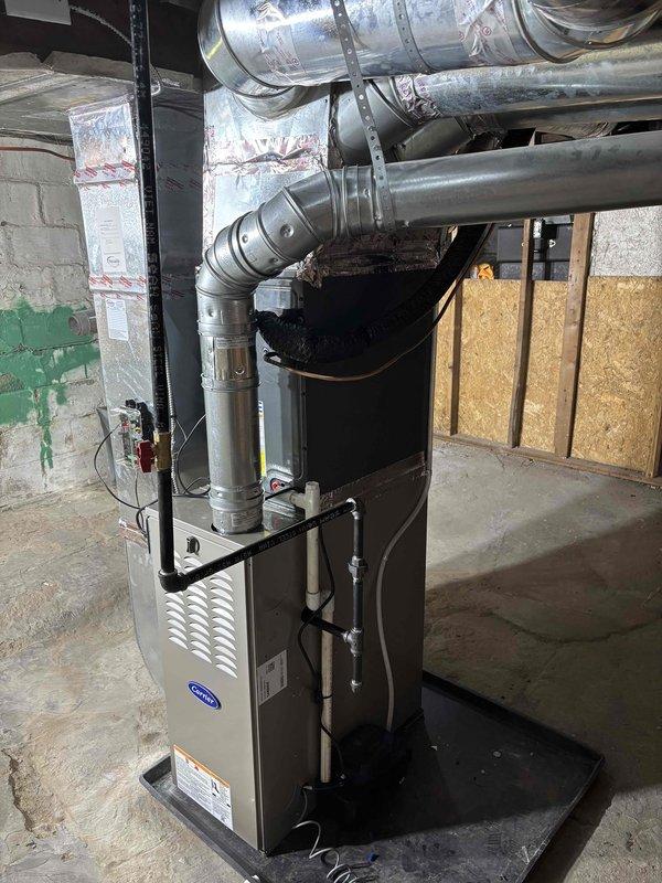 Completed installation of personal use HVAC equipment including indoor furnace unit and outdoor condensing unit. Installed Carrier brand furnace in basement mechanical room with proper exhaust pipe assembly and metallic ductwork connections. Mounted Amana brand air conditioning condensing unit on concrete pad in backyard area between property fences, with electrical disconnect box installed on exterior wall and refrigerant lines properly routed to indoor unit. All equipment positioned according to manufacturer specifications with adequate clearances for service access and proper ventilation. System connections completed and documented with photographic records of installation.