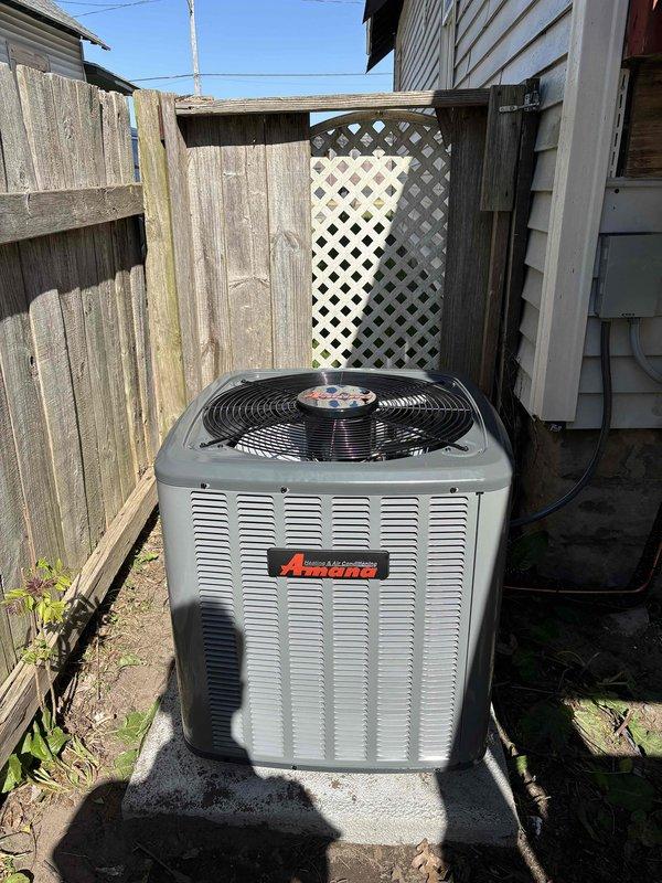 Completed installation of personal use HVAC equipment including indoor furnace unit and outdoor condensing unit. Installed Carrier brand furnace in basement mechanical room with proper exhaust pipe assembly and metallic ductwork connections. Mounted Amana brand air conditioning condensing unit on concrete pad in backyard area between property fences, with electrical disconnect box installed on exterior wall and refrigerant lines properly routed to indoor unit. All equipment positioned according to manufacturer specifications with adequate clearances for service access and proper ventilation. System connections completed and documented with photographic records of installation.