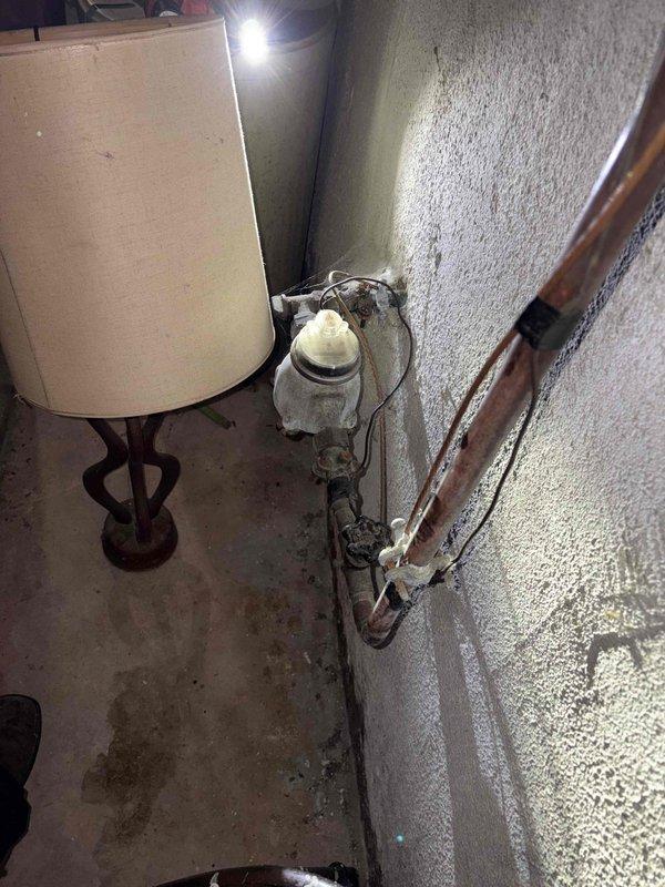 Responded to outdoor faucet leak identified during previous AC maintenance visit. Upon arrival, inspected exterior hose bib and traced supply line to basement connection point. Found frost accumulation on copper supply piping in basement, indicating active leak at outdoor faucet connection causing water flow and temperature differential. Shut off water supply, removed leaking outdoor faucet assembly, cleaned threads and connection points, applied pipe thread sealant, and installed replacement hose bib. Restored water supply and pressure tested system to verify leak elimination and proper operation. Confirmed no water discharge at exterior connection point and no further frost formation on basement piping.