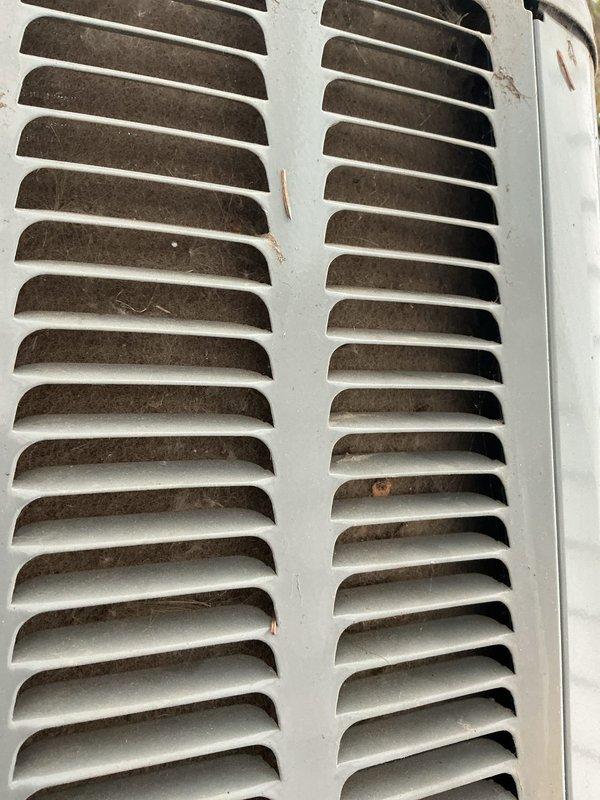 Completed comprehensive ASTU-AC Super Tune-up service on a 7-year-old EnergiAir unit with warranty extending to June 2028. Performed thorough inspection of outdoor condenser unit, documenting significant dust and debris accumulation on ventilation grilles and heat exchanger fins, along with visible oxidation and moisture presence on exterior louvers. Cleaned condenser coils, cleared obstructions from airflow passages, and verified proper system operation to maintain warranty compliance and optimize cooling efficiency.