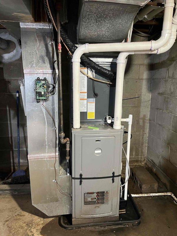 Completed full air conditioning system replacement and installation. Installed new AC unit with proper refrigerant charging per factory specifications, verified system pressures and temperatures within acceptable ranges. Connected refrigerant lines to furnace system, secured all electrical connections, and integrated new equipment with existing ductwork and HVAC infrastructure in basement mechanical area.