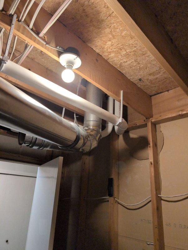 Completed full furnace installation in basement utility area. Installed new gray metal furnace unit with proper venting using white PVC piping extending vertically from the unit. Connected air handler/filter cabinet to system and ensured proper integration with existing ductwork, including rectangular and round flexible ducts. Verified all manufacturer specifications and safety requirements were met. System tested and confirmed operational upon completion.