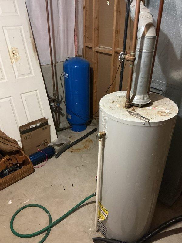 Responded to no hot water complaint affecting entire residence. Assessed existing 20-year-old water heater in basement utility area showing signs of age and deterioration, including visible rust staining on tank surface. Provided estimate for complete water heater replacement with professional installation, including removal of existing unit and proper connection of copper supply lines, venting system, and electrical components.