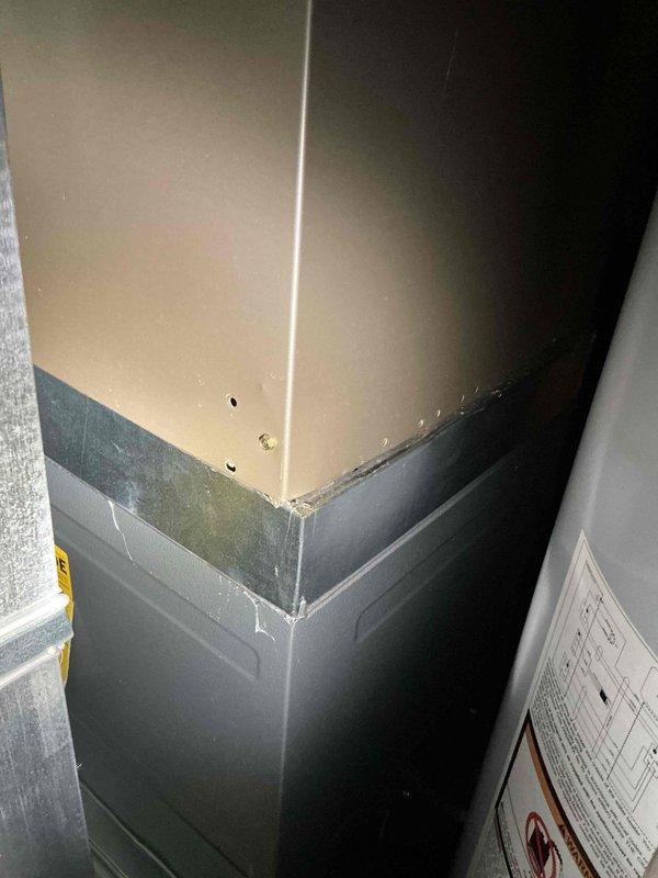 Responded to no cooling complaint on Bryant HVAC system with reported flooding. Upon inspection, discovered water intrusion had affected the air handler unit, causing system shutdown. Documented interior components including control board, refrigerant lines, and electrical connections, all of which showed exposure to moisture. Observed water damage on surrounding walls with visible deterioration, cracking, and separation at wall junctions, confirming the extent of the leak. Photographed affected areas including compromised wall surfaces and damaged interior mechanical room conditions. System required assessment for water damage to electrical components and potential replacement of affected parts to restore cooling operation.